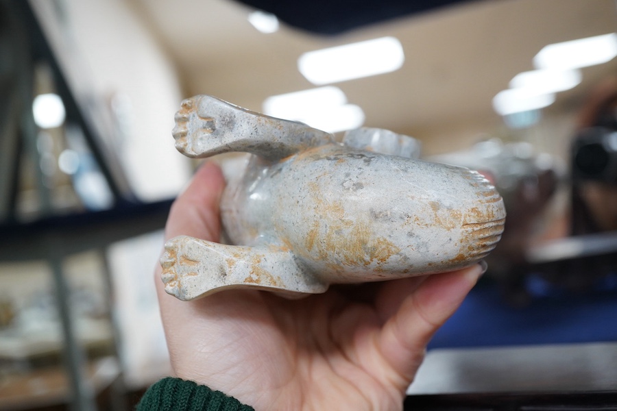 A large Chinese archaistic pale celadon and calcified jade rhyton, on a hardwood stand, 17.5cm high. Condition - fair to good.